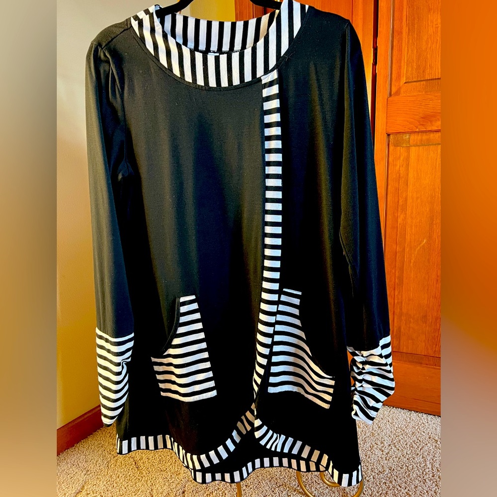 Black with black and white stripe details. Size large. Tunic.34”L washable